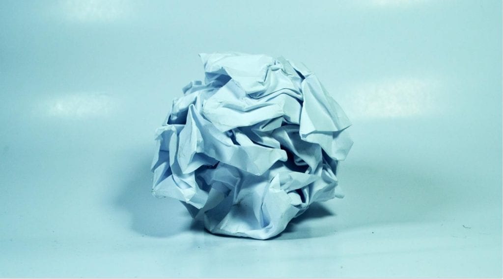 A crushed ball of paper; a mistake